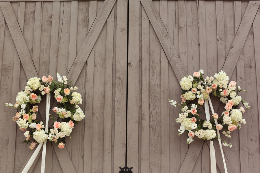 The barn doors were dressed up with romantic wreaths made from