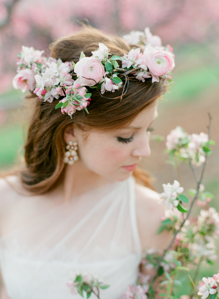 The bride wore a romantic pale pink floral crown of ranunculus and